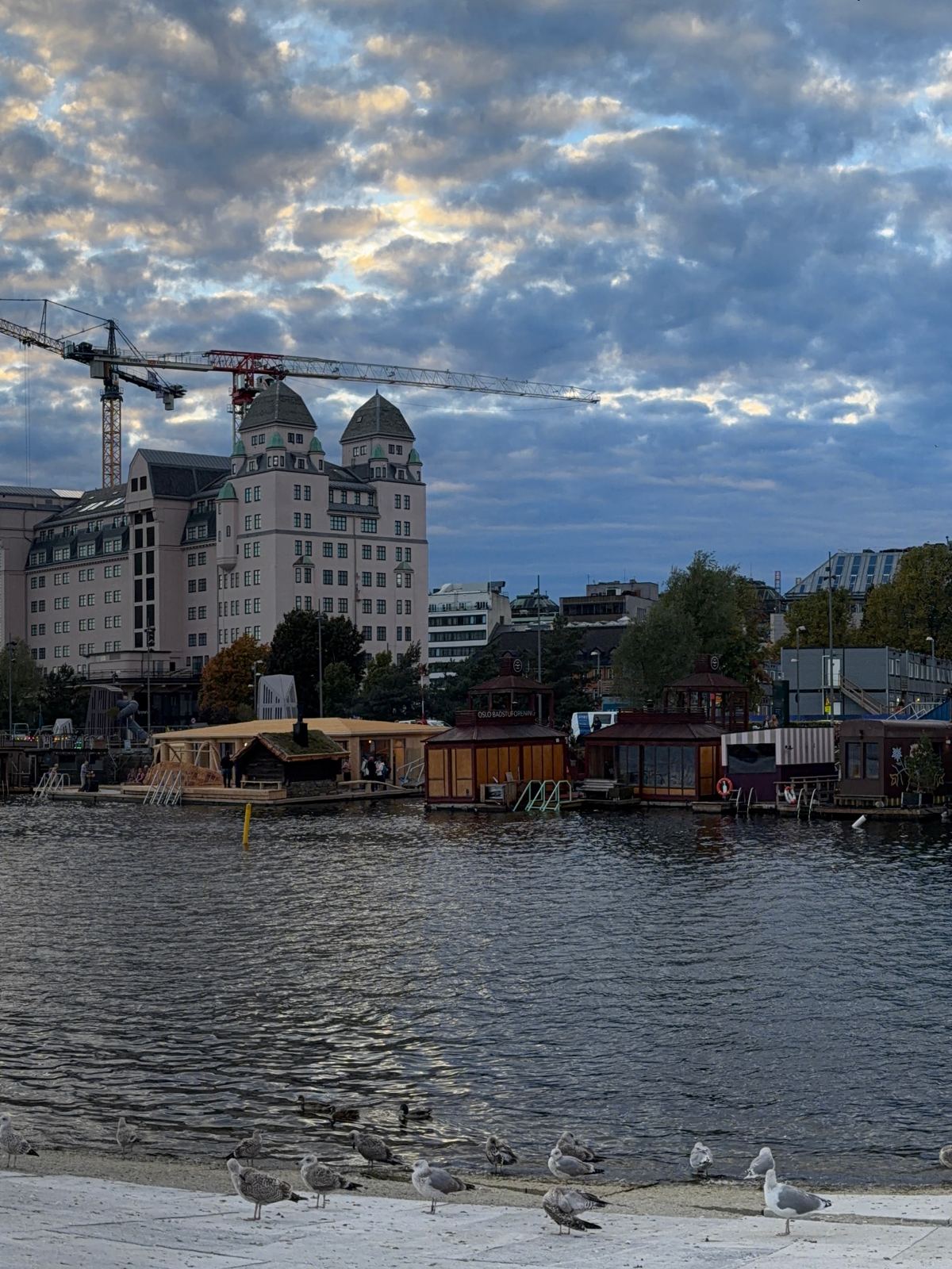 Floating saunas on the Oslo harbour under a big sky